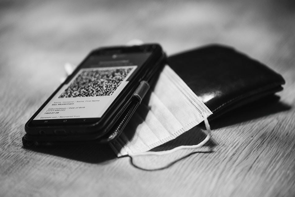 Image of a mobile phone showing a QR code separated from a wallet by a protective mask