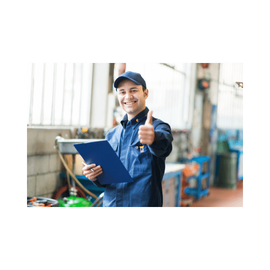 A mechanic wearing blue overalls giving a thumbs-up
