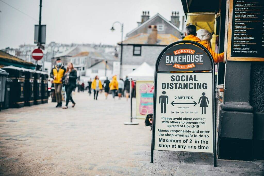 covid-19 social distancing sign outside of a pasty shop